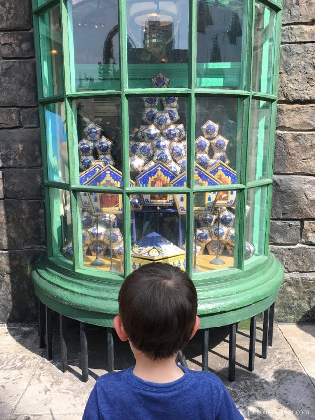 Using an interactive wand at The Wizarding World of Harry Potter, Orlando, Florida